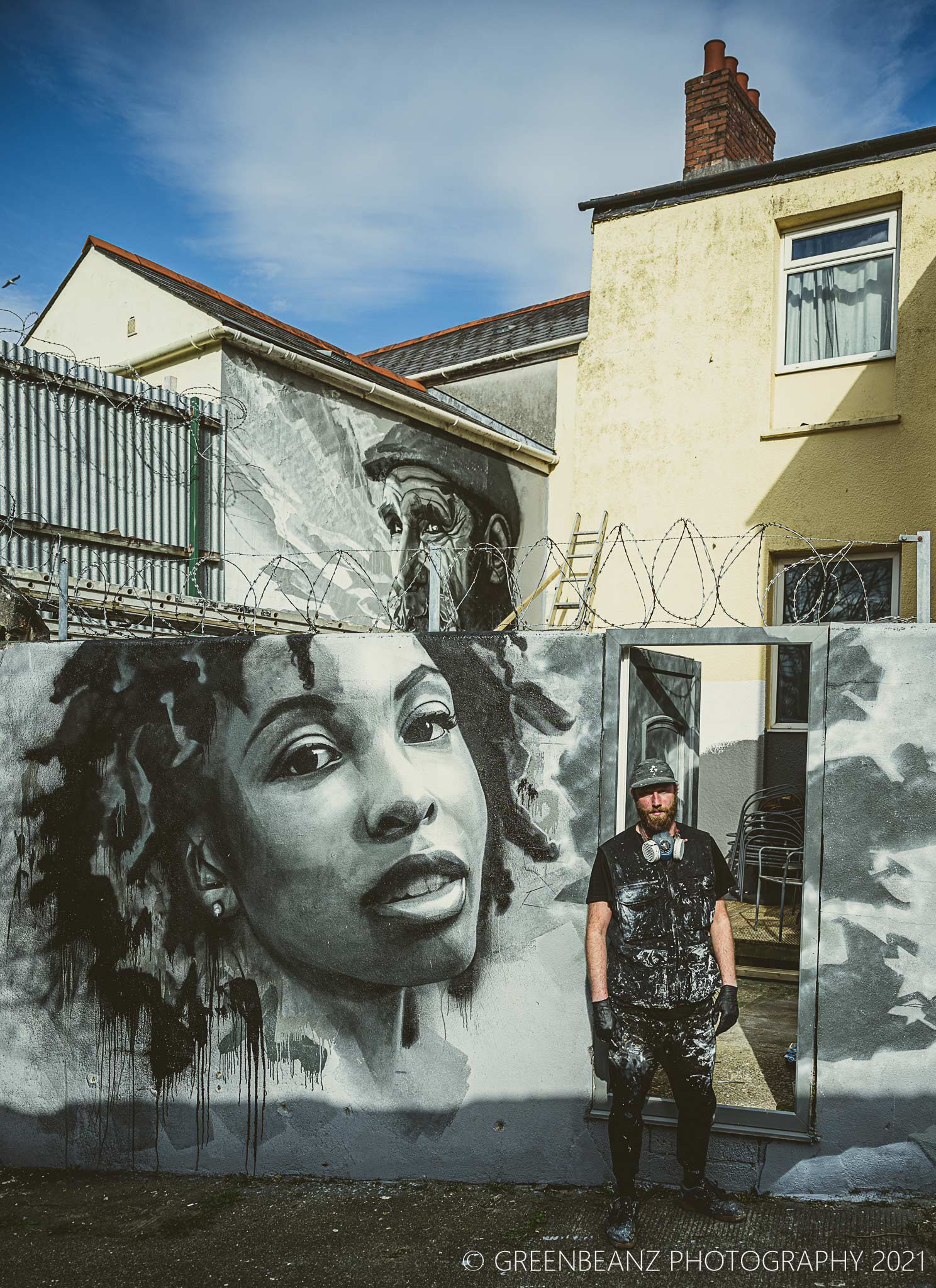 Mural Artist Joe Greeaway in front of a Plymouth Commission