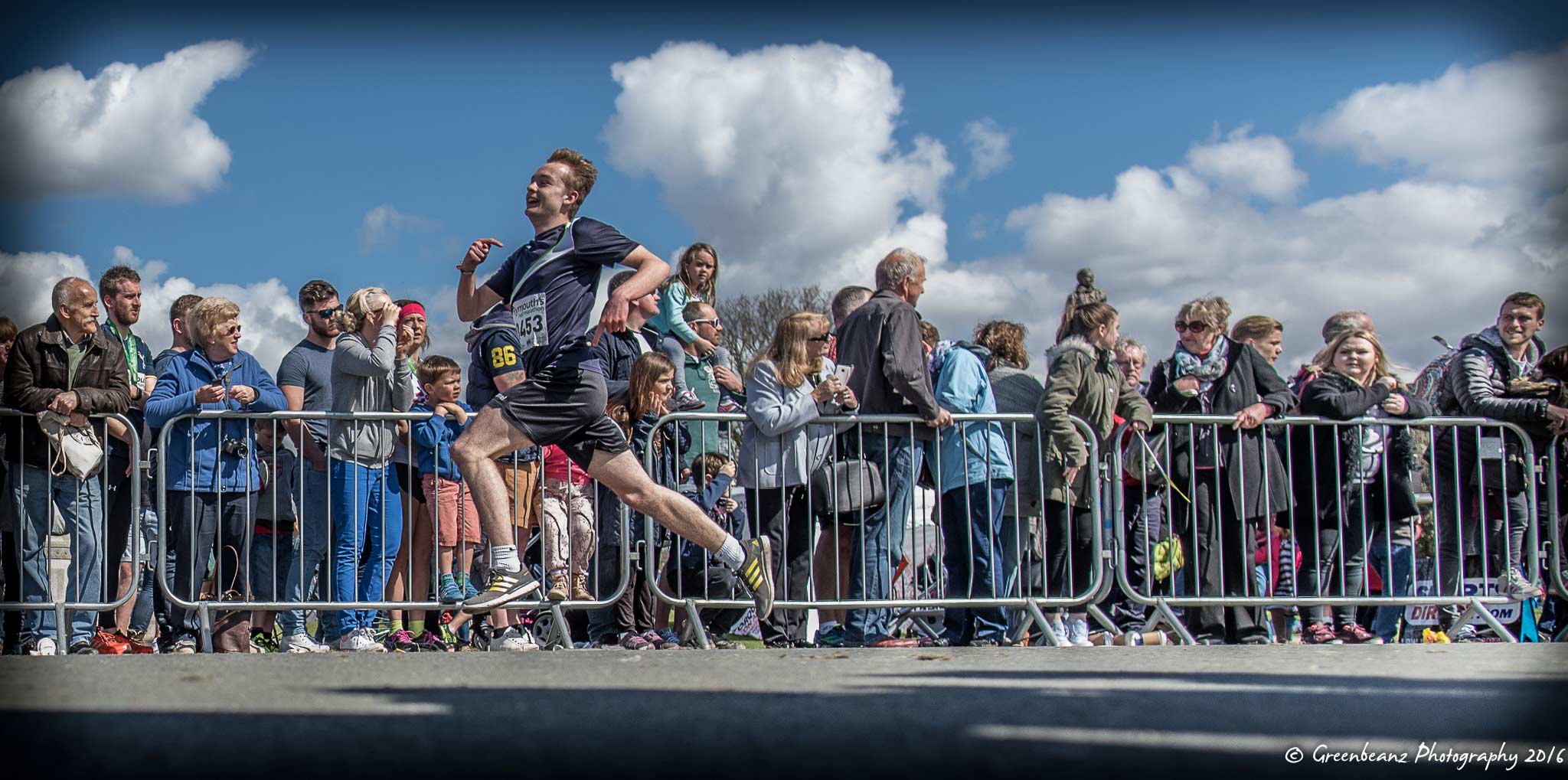 Plymouth runner jumping in air at race end