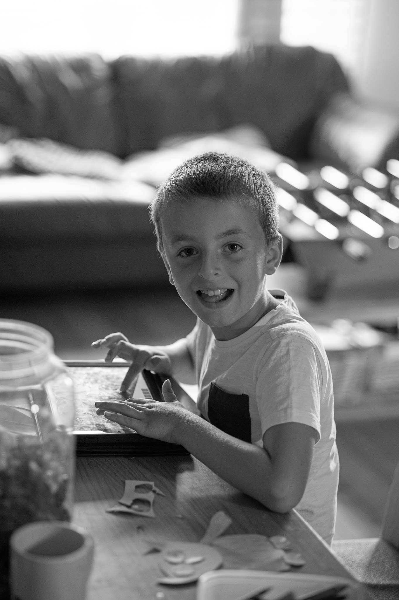 Caden with tablet in Plymouth home family photo shoot