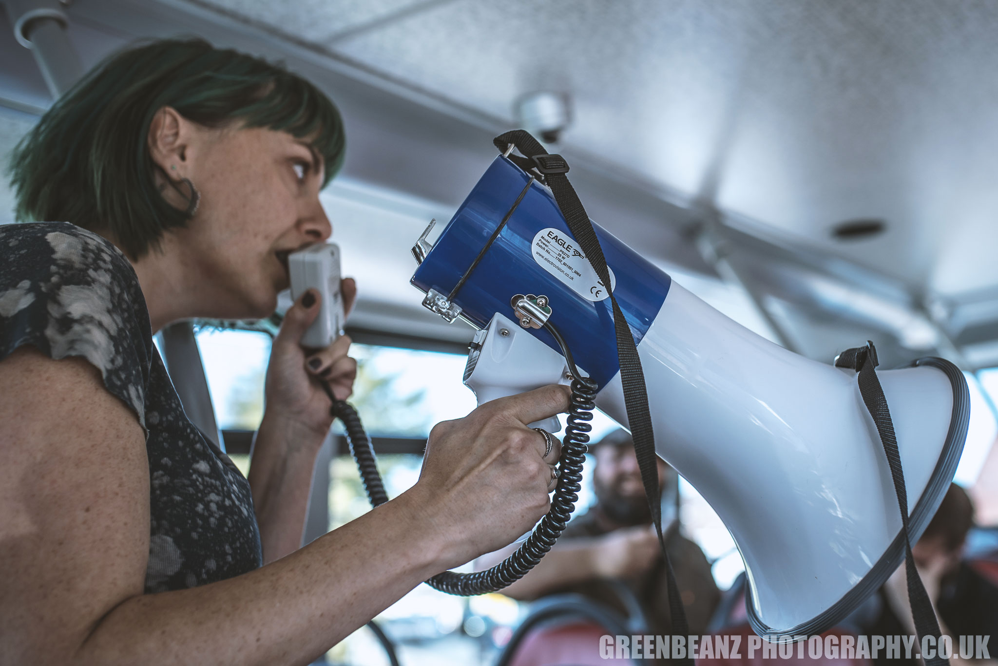 Marion Claire with a megaphone performs her poem 'Whales' to a captive audience