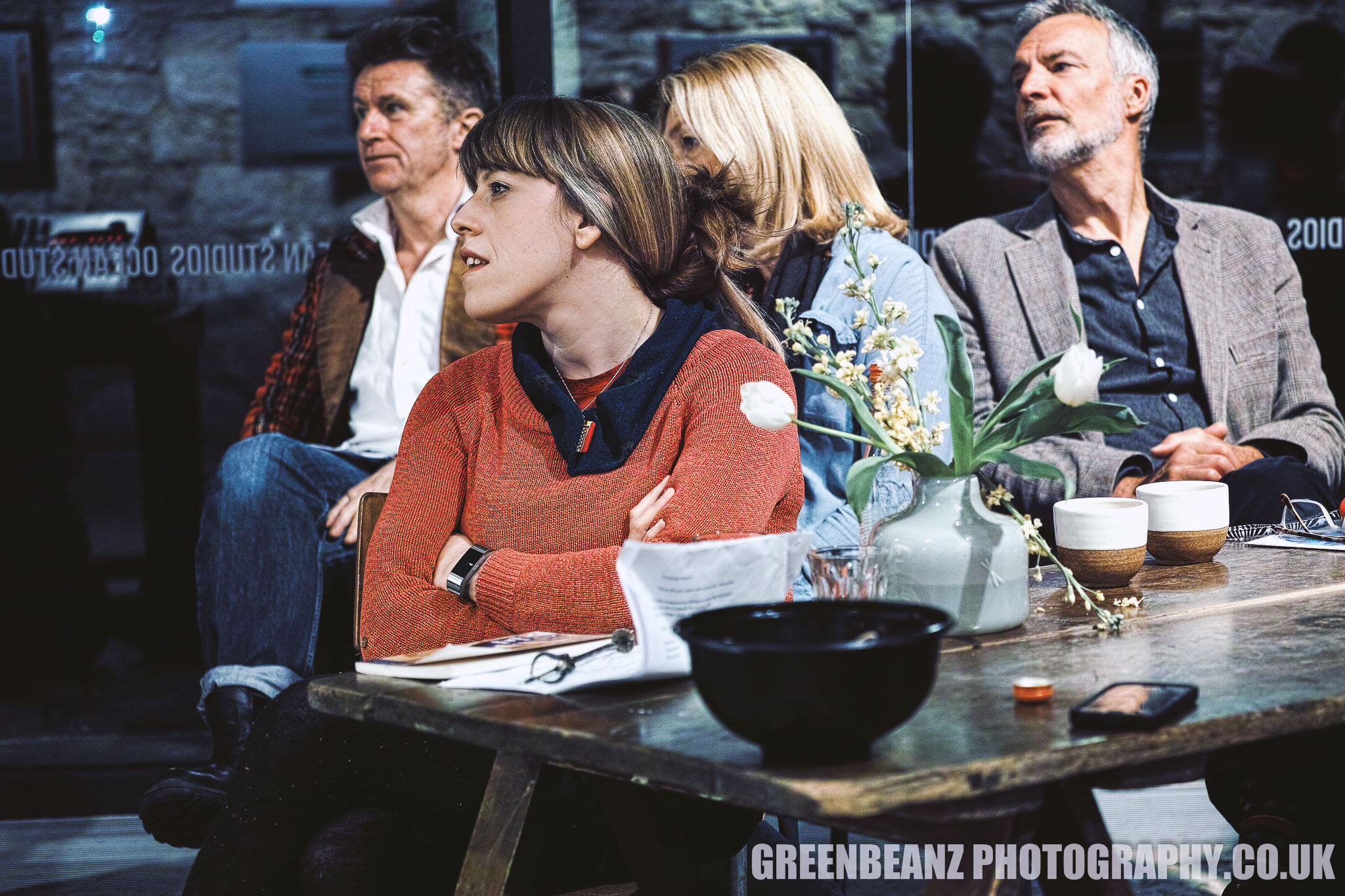 An attentive audience listens to Jack Dean's spoken word performance in Plymouth