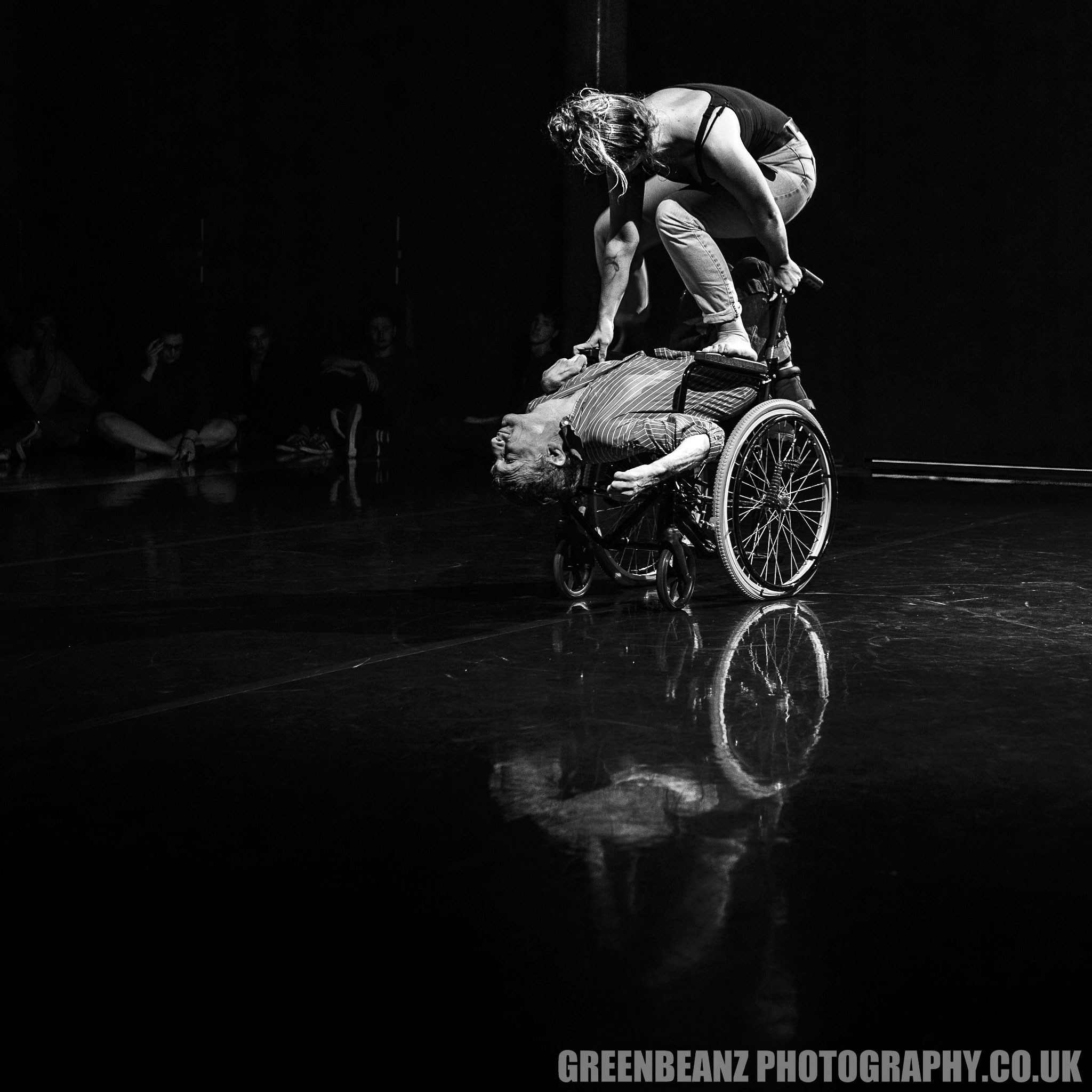 Cloe Lee stands on Kevin's wheelchair during dance sequence