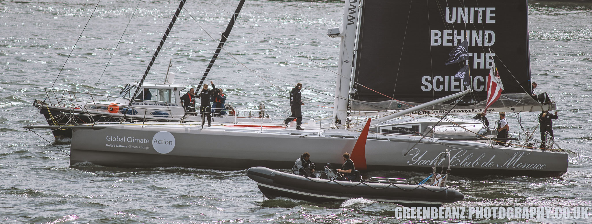 Greta Thunberg waves from on baord Malizia II in Plymouth Sound