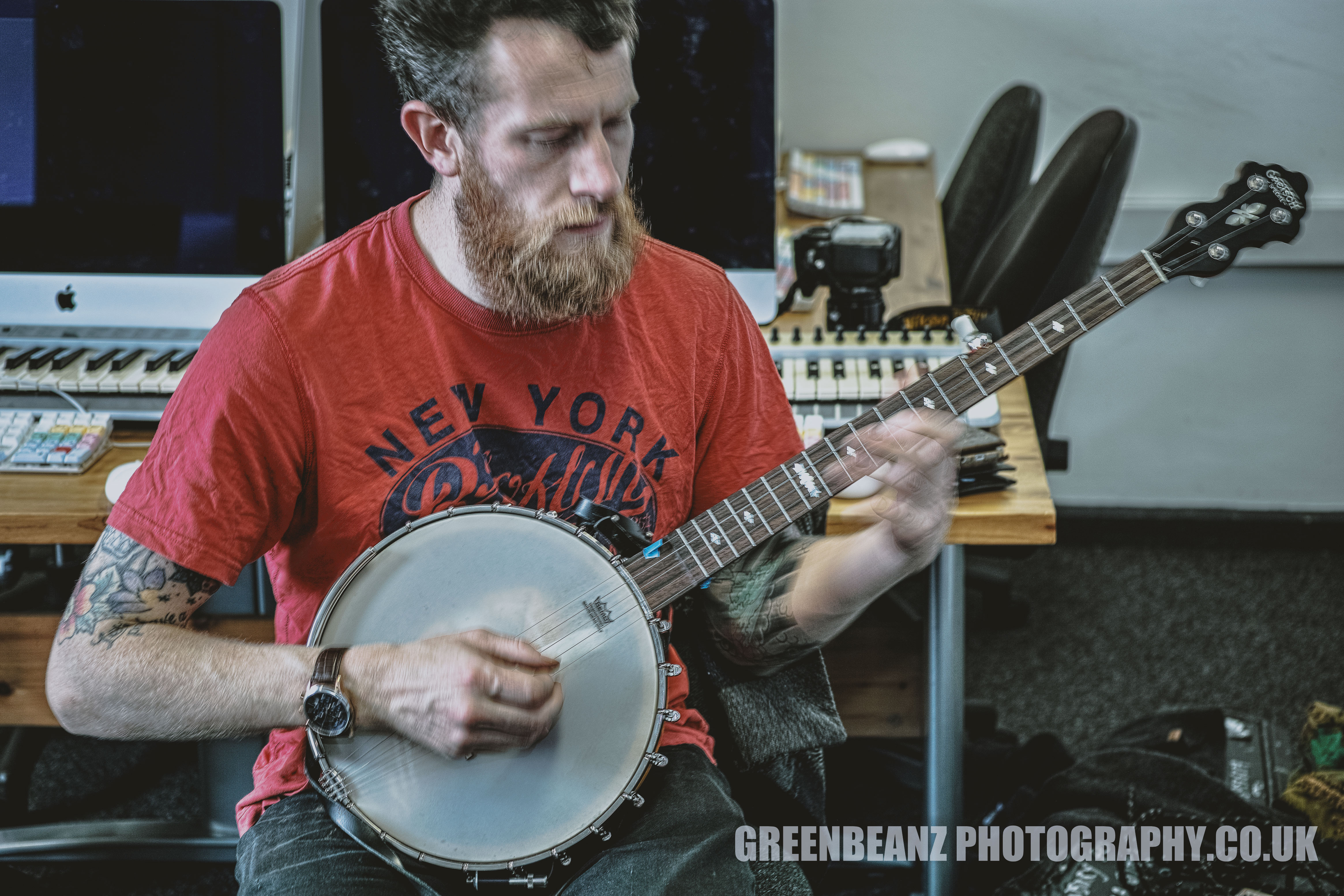 Seated Banjo Player photgraphed slow shutter speed hand held by Plymouth Photographer