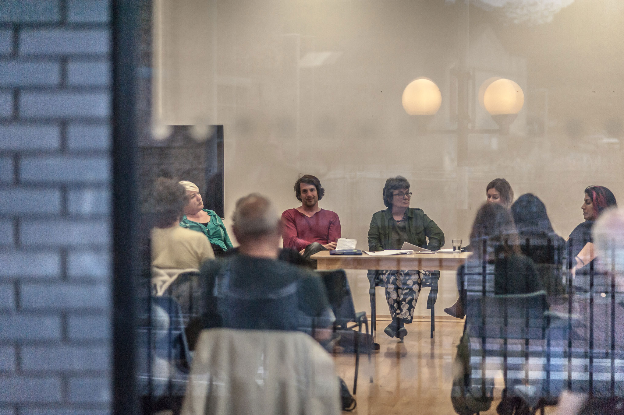 Seated workshop photgraphed thru glass