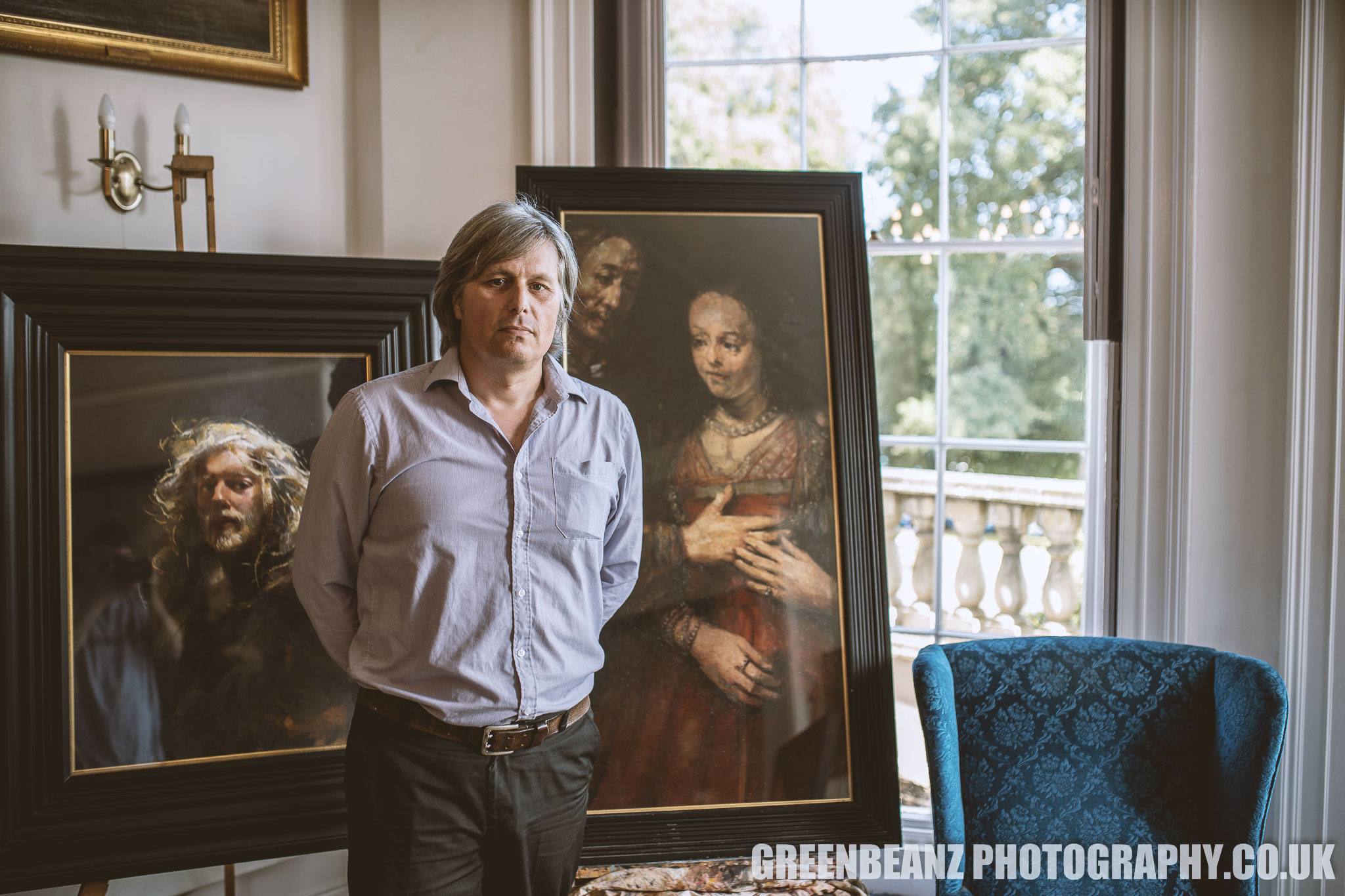 Reuben Lenkiewicz in front of his father Robert Lenkiewicz paintings at the show