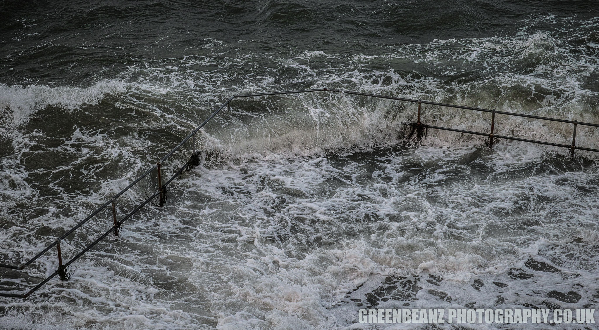 Waves crashing thru railings on Plymouth Hoe during Storm Brian 2017