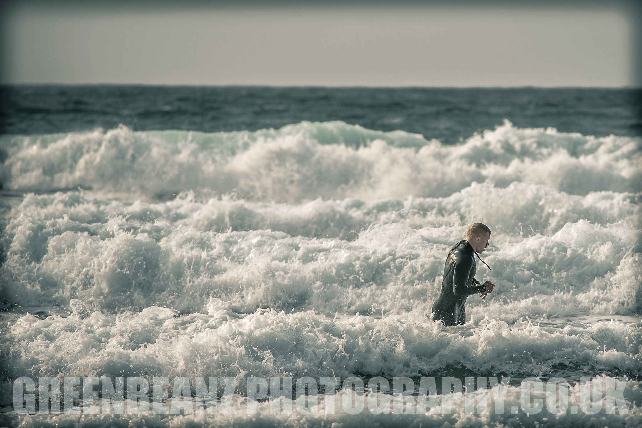 Surfer leaving the water at the end of the day