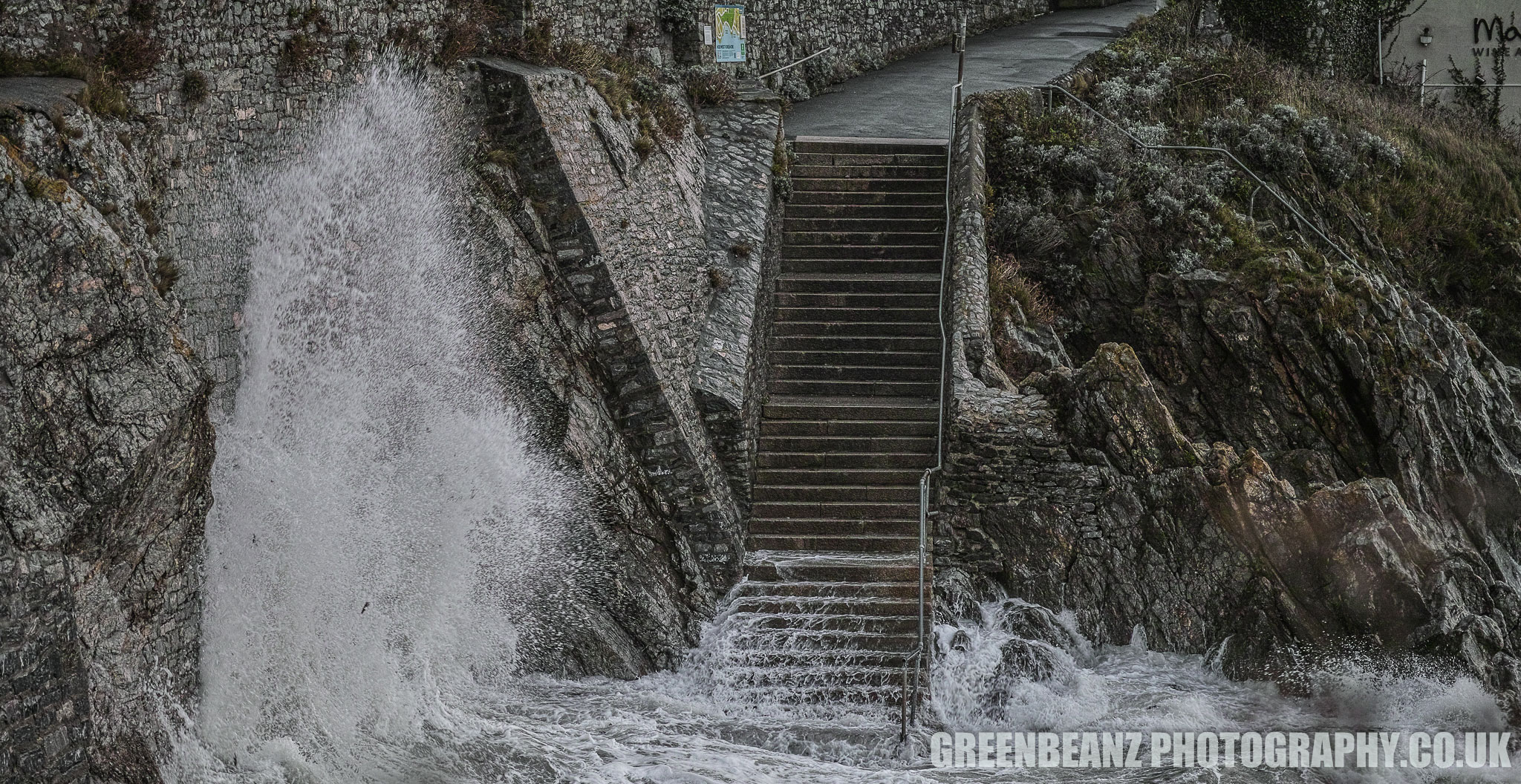 Waves crashing against the wall on Plymouth Hoe during Storm Brian 2017