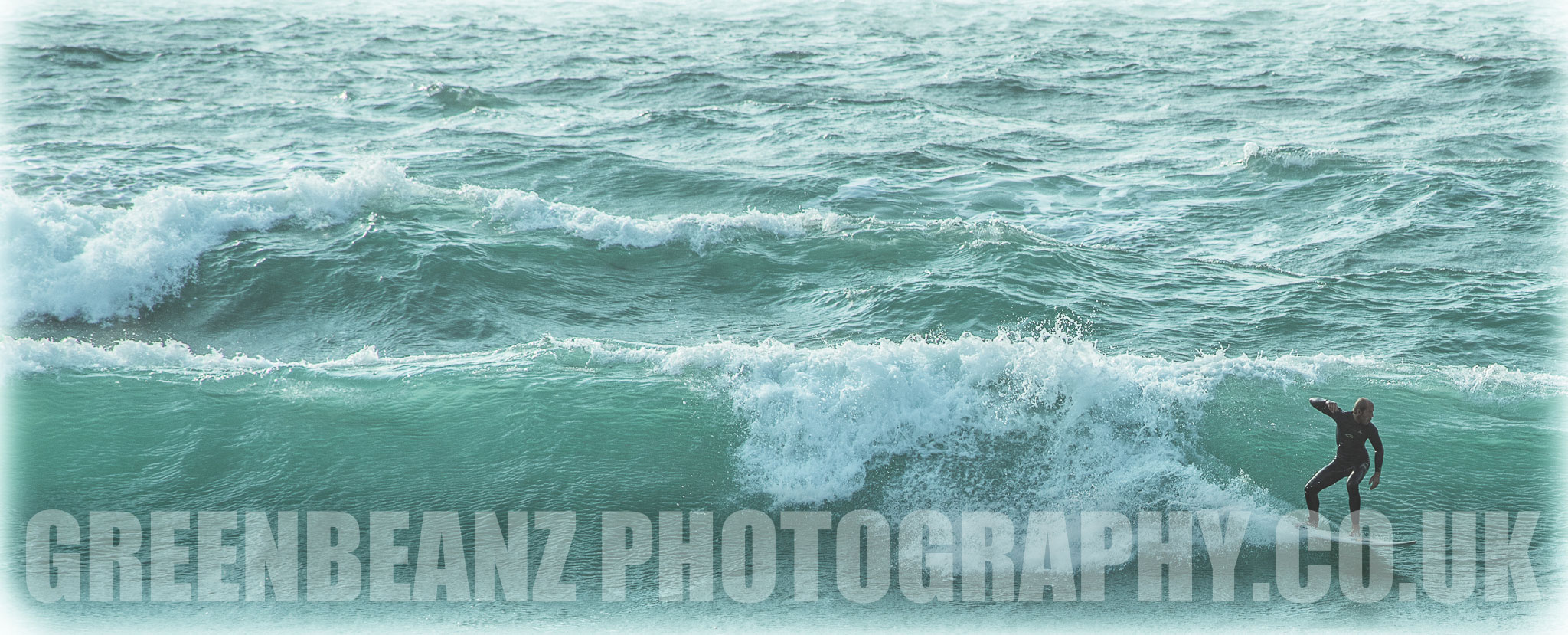 Surfer catching a wave off Newquay 