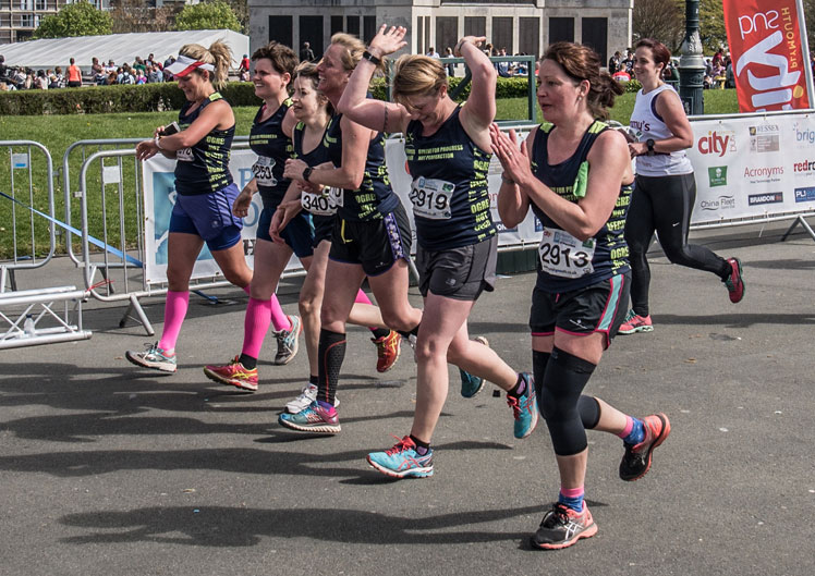 Group of runners crossing finish line