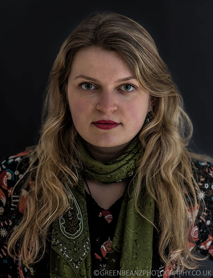 Seated Blonde musician Eliza with green scarf