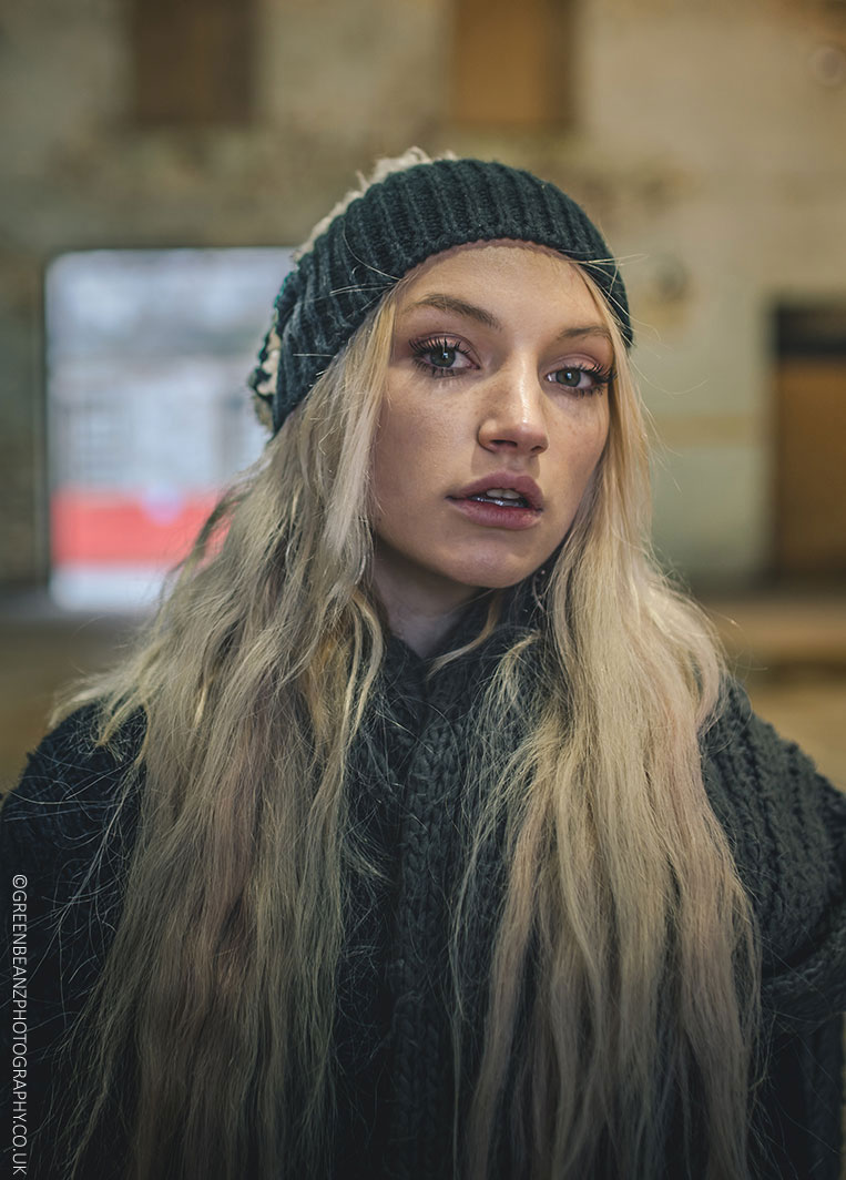 Portrait of model with long blonde hair and woolly hat